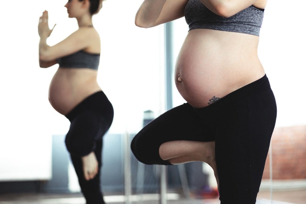 Pregnant woman doing yoga exercise.